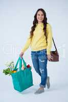 Beautiful woman carrying grocery bag