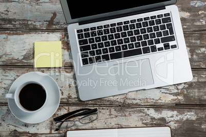 Laptop and office accessories with coffee cup