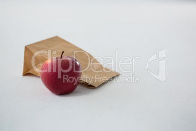 Brown paper parcel bag with red apple