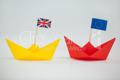 Two paper boats with union jack and european union flag