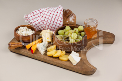 Loaf of bread with cheese, knife and jam
