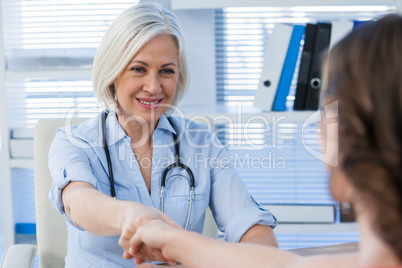 Female doctor shaking hands with patient