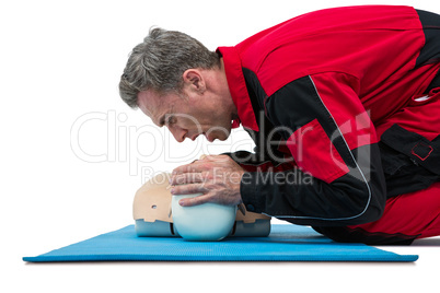 Paramedic blowing oxygen to dummy