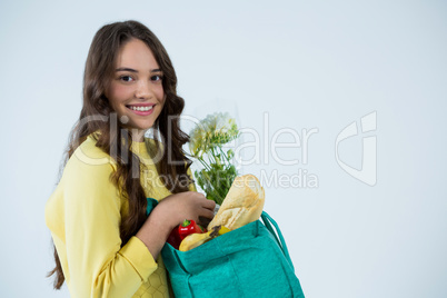 Beautiful woman carrying grocery bag