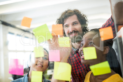 Business executives reading sticky notes