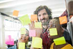 Business executives reading sticky notes