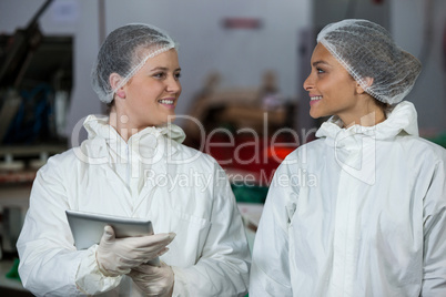 Female butchers interacting with each other