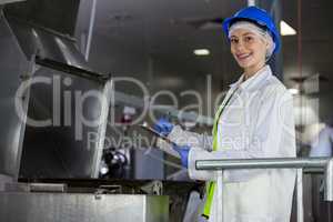 Technician examining meat processing machine