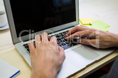 Graphic designer using digital tablet at his desk