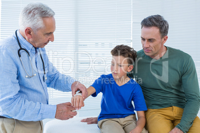 Doctor tying hand band on hand of a patient