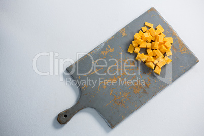 Cheddar cheese slices on cutting board