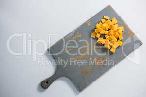 Cheddar cheese slices on cutting board