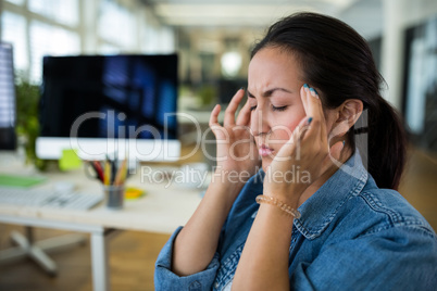 Stressed female business executive at desk