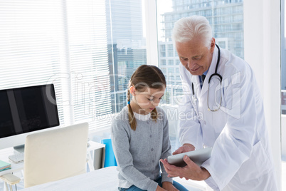 Doctor and patient discussing over digital tablet