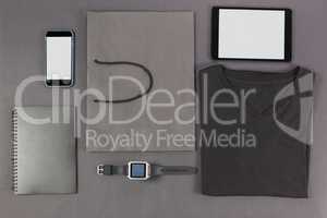 Smartphone, digital tablet, diary, folded t-shirt, shopping bag and watch