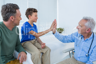 Doctor giving high five to a patient