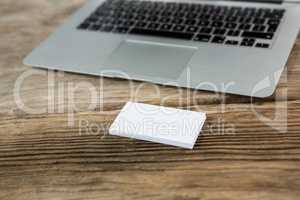 Laptop with sticky notes on wooden table