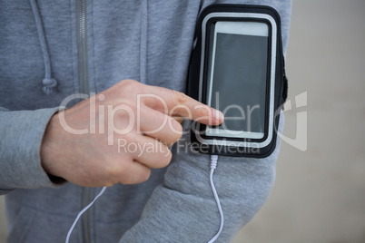 Mid section of man using mobile phone