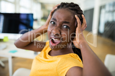 Frustrated female business executive at desk