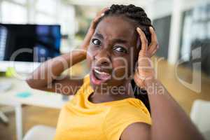 Frustrated female business executive at desk