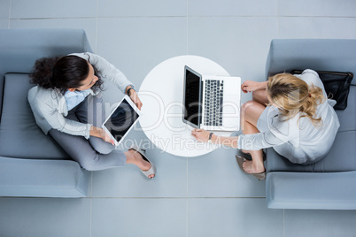 Businesswomen using laptop and digital tablet