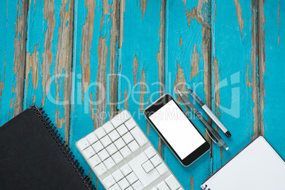 Smartphone, notepad and keyboard placed together