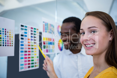 Graphic designers looking at color chart