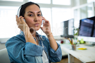 Portrait of woman listening to music on headphones