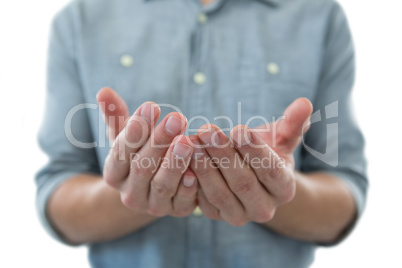 Cupped hands of man pretending to hold an invisible object