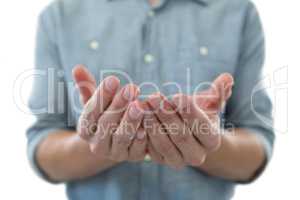 Cupped hands of man pretending to hold an invisible object