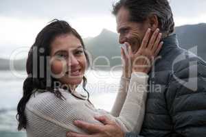 Romantic couple embracing each other on beach