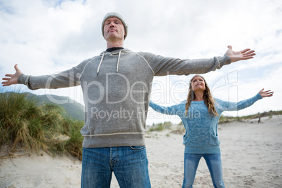 Couple standing with arms outstretched Couple standing with arms outstretched