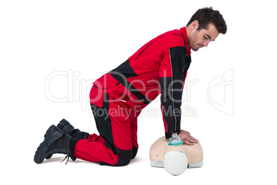 Paramedic practising resuscitation on dummy