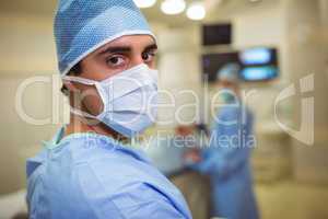 Portrait of male surgeon wearing surgical mask in operation theater