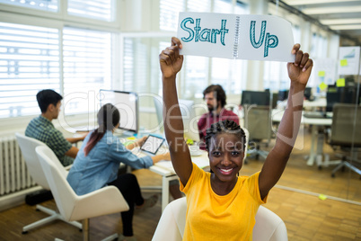 Female business executive holding diary with text start up