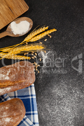 Bread loaf with wheat grains and flour