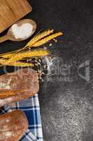 Bread loaf with wheat grains and flour