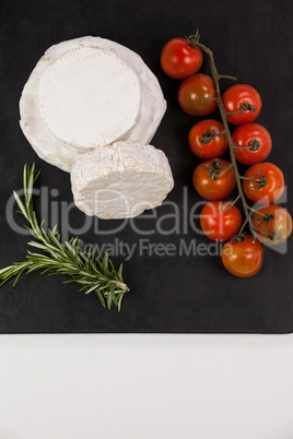 Cheese with cherry tomatoes and rosemary herb