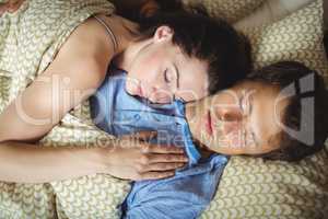 Romantic couple sleeping on bed