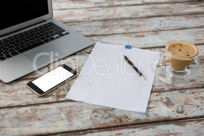 Laptop with smartphone and cup of coffee