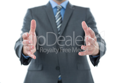 Businessman gesturing against white background