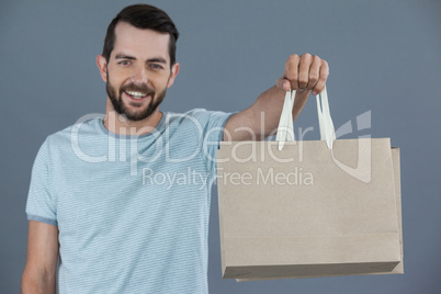 Happy man holding shopping bags