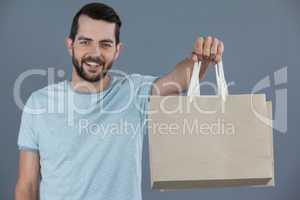 Happy man holding shopping bags
