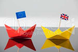 Two paper boats with union jack and european union flag