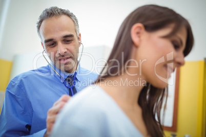 Doctor examining a female patient