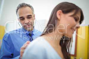 Doctor examining a female patient