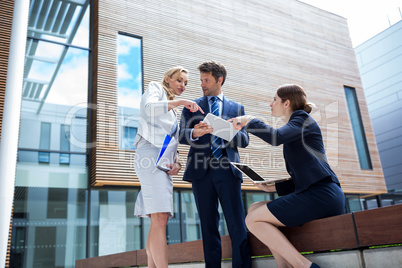 Businesspeople using laptop and digital tablet