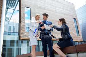 Businesspeople using laptop and digital tablet