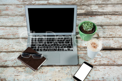 Laptop, smartphone and diary with cup of coffee