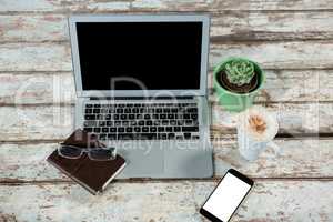 Laptop, smartphone and diary with cup of coffee